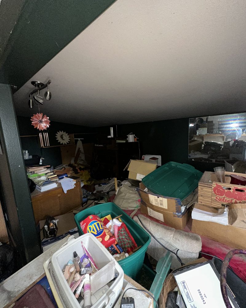 A bedroom before, full of belongings